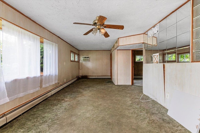 2354 7th St, East Meadow, NY 11554 - carpeted spare room featuring a baseboard heating unit, ceiling fan, a textured ceiling, an AC wall unit, and healthy amount of natural light
