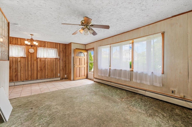 2354 7th St, East Meadow, NY 11554 - tiled empty room featuring baseboard heating, wood walls, a ceiling fan, a chandelier, and carpet flooring