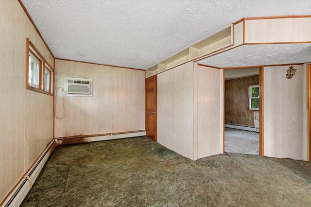 2354 7th St, East Meadow, NY 11554 - carpeted empty room with a baseboard radiator, wood walls, a textured ceiling, and a wall mounted air conditioner