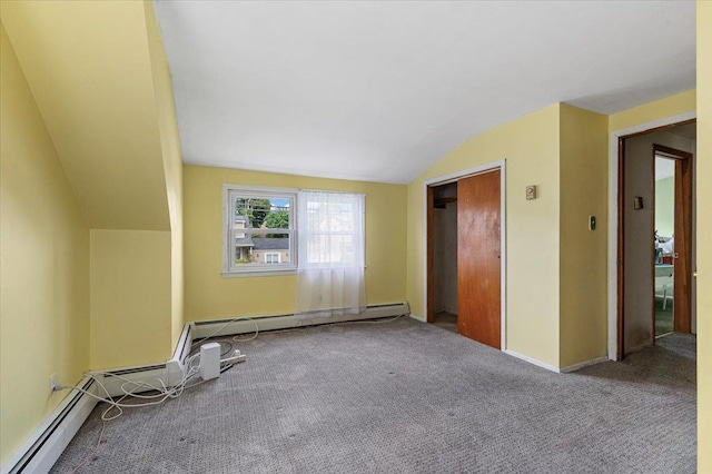 2354 7th St, East Meadow, NY 11554 - unfurnished bedroom with lofted ceiling, carpet flooring, and a baseboard heating unit