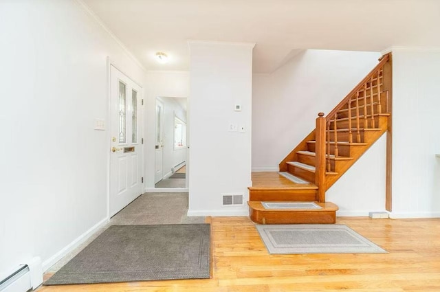 40-02 202nd St, Bayside, NY 11361 - stairs featuring wood finished floors, crown molding, and a baseboard heating unit