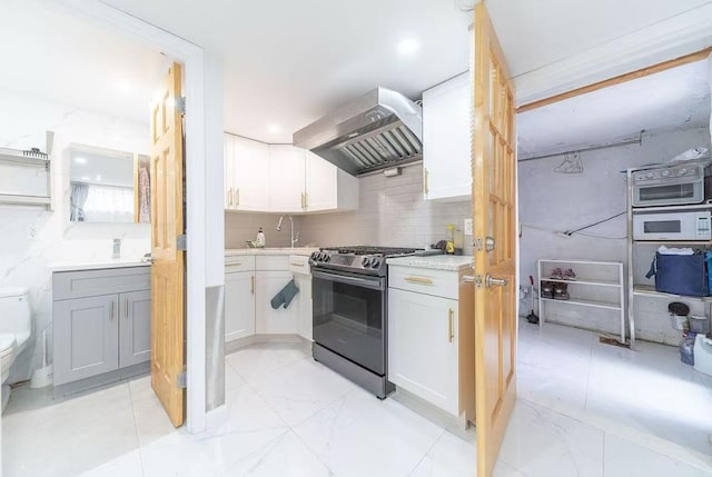 40-02 202nd St, Bayside, NY 11361 - kitchen featuring stainless steel range with gas stovetop, wall chimney range hood, white microwave, light countertops, and tasteful backsplash