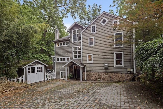 41 River Rd, Nyack, NY 10960 - view of front facade with a patio area, a storage shed, and a chimney