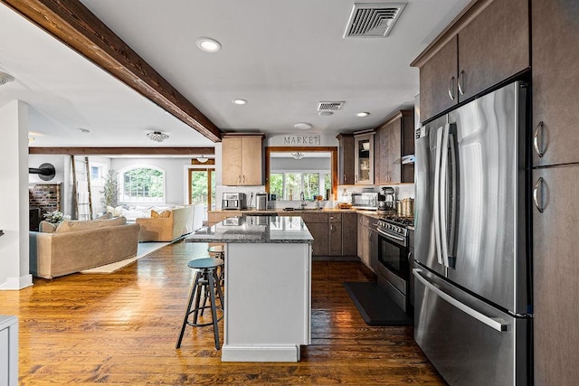 41 River Rd, Nyack, NY 10960 - kitchen with appliances with stainless steel finishes, a kitchen breakfast bar, recessed lighting, open floor plan, and dark stone counters