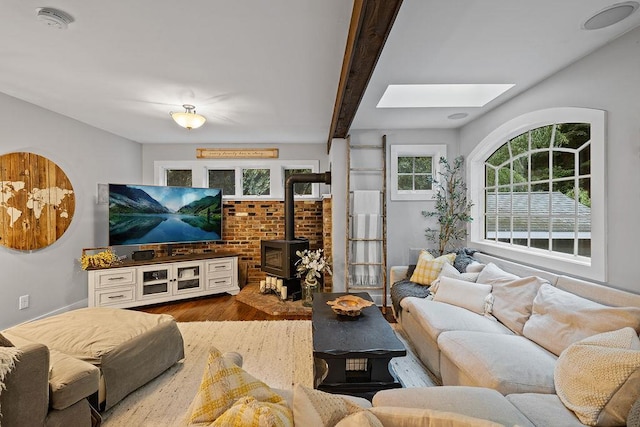 41 River Rd, Nyack, NY 10960 - living area with a skylight, wood finished floors, a wood stove, and beam ceiling