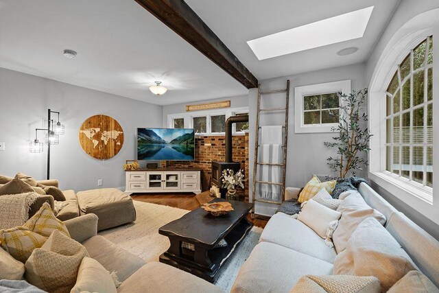 41 River Rd, Nyack, NY 10960 - living room with a skylight, wood finished floors, beam ceiling, and a wood stove
