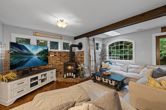 41 River Rd, Nyack, NY 10960 - living room featuring a wood stove, wood finished floors, and beamed ceiling