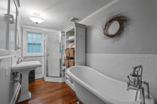 41 River Rd, Nyack, NY 10960 - full bathroom featuring a shower stall, crown molding, wood finished floors, and a freestanding bath