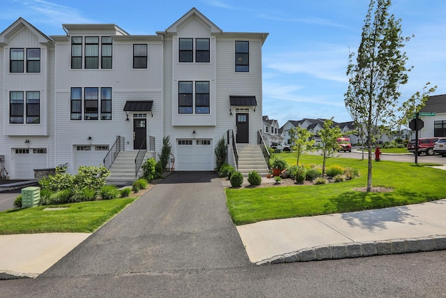 23 Champlain Way, Wappingers Falls, NY 12590 - multi unit property with an attached garage, asphalt driveway, a front lawn, board and batten siding, and a residential view