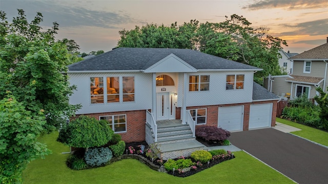 2508 Centre Ave, Bellmore, NY 11710 - bi-level home with brick siding, asphalt driveway, roof with shingles, and a front lawn