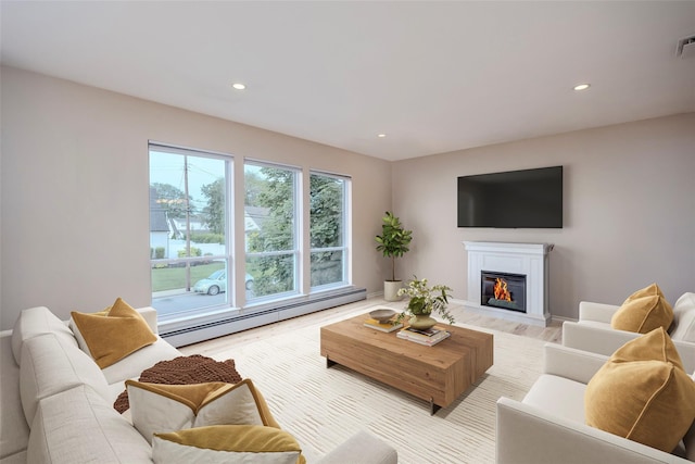 2508 Centre Ave, Bellmore, NY 11710 - living room featuring a baseboard heating unit, a glass covered fireplace, recessed lighting, and light wood-style flooring