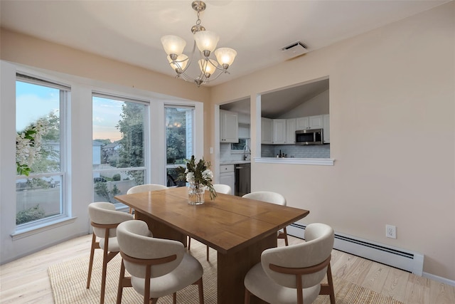 2508 Centre Ave, Bellmore, NY 11710 - dining area featuring a chandelier, a baseboard radiator, light wood finished floors, and vaulted ceiling