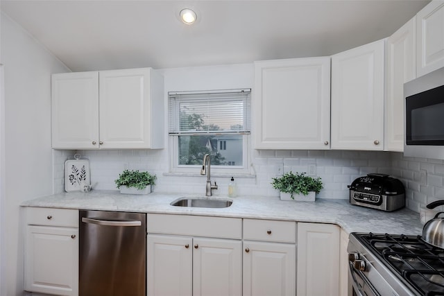 2508 Centre Ave, Bellmore, NY 11710 - kitchen featuring stainless steel appliances, backsplash, white cabinetry, light stone counters, and recessed lighting