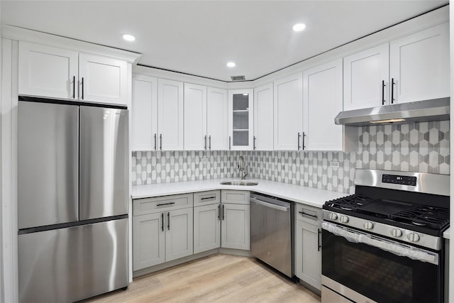 2 Bay Club Dr Unit 3P, Bayside, NY 11360 - kitchen with appliances with stainless steel finishes, under cabinet range hood, light countertops, decorative backsplash, and recessed lighting