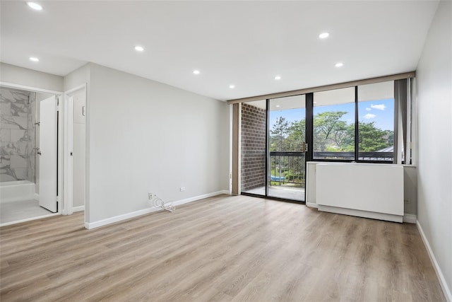 2 Bay Club Dr Unit 3P, Bayside, NY 11360 - empty room with recessed lighting, light wood-type flooring, and floor to ceiling windows