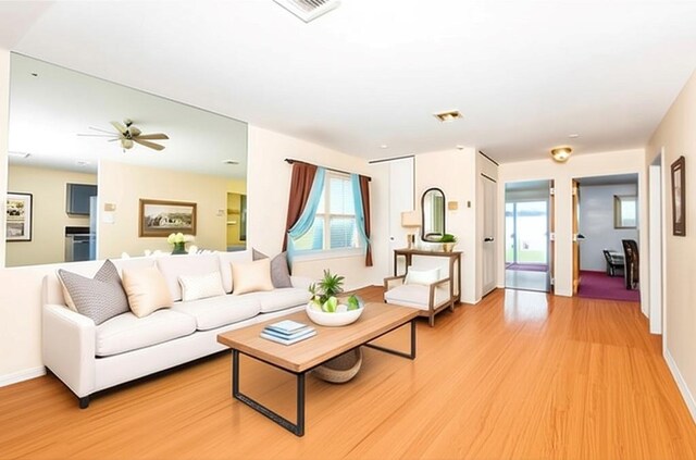137 Eastbourne Ct Unit A, Ridge, NY 11961 - living room featuring light wood-type flooring, healthy amount of natural light, and ceiling fan