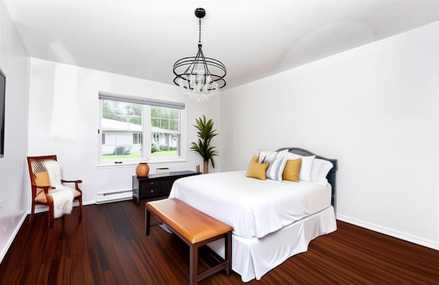 137 Eastbourne Ct Unit A, Ridge, NY 11961 - bedroom with a chandelier, wood finished floors, and a baseboard radiator