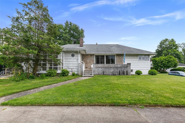 11 Webb Hill Rd, Great Neck, NY 11020 - view of front of house featuring a front yard, a chimney, stone siding, and roof with shingles