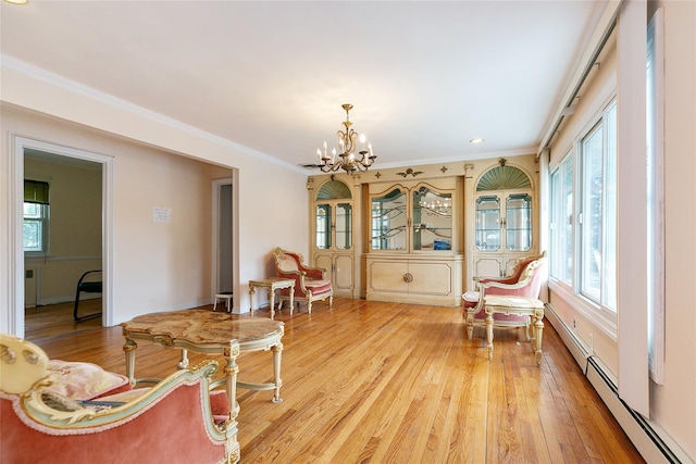 11 Webb Hill Rd, Great Neck, NY 11020 - sitting room with a chandelier, light wood-style floors, plenty of natural light, and ornamental molding