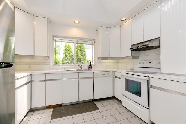 11 Webb Hill Rd, Great Neck, NY 11020 - kitchen with white appliances, under cabinet range hood, light countertops, backsplash, and recessed lighting