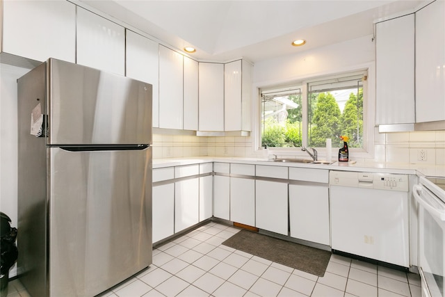 11 Webb Hill Rd, Great Neck, NY 11020 - kitchen with freestanding refrigerator, white dishwasher, light countertops, white cabinets, and tasteful backsplash
