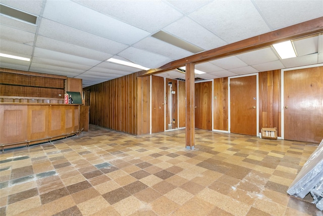 11 Webb Hill Rd, Great Neck, NY 11020 - finished below grade area with a paneled ceiling, wooden walls, bar area, and tile patterned floors