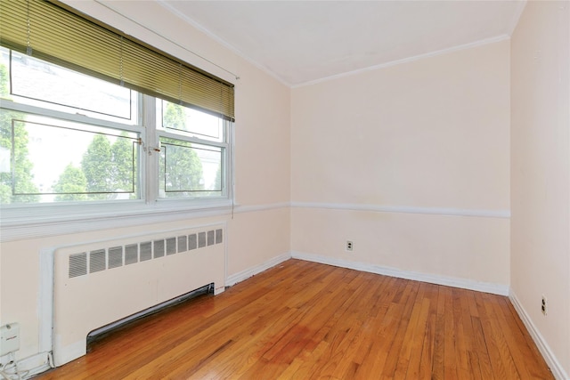 11 Webb Hill Rd, Great Neck, NY 11020 - unfurnished room with radiator heating unit, ornamental molding, and light wood-type flooring