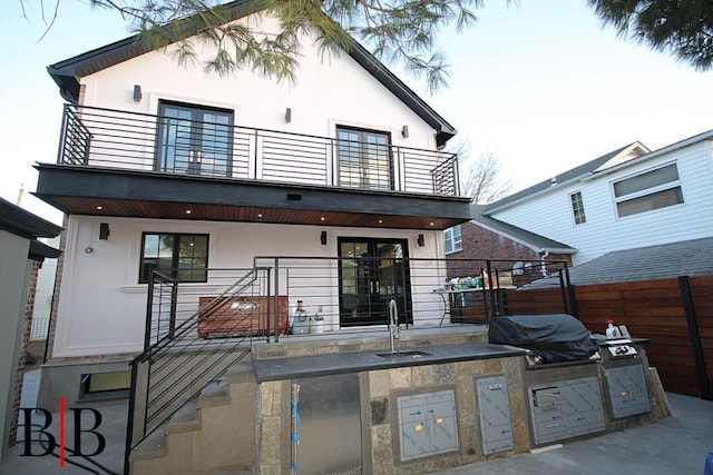 82 Piedmont Ave, Staten Island, NY 10305 - rear view of property with a balcony, an outdoor kitchen, and stucco siding