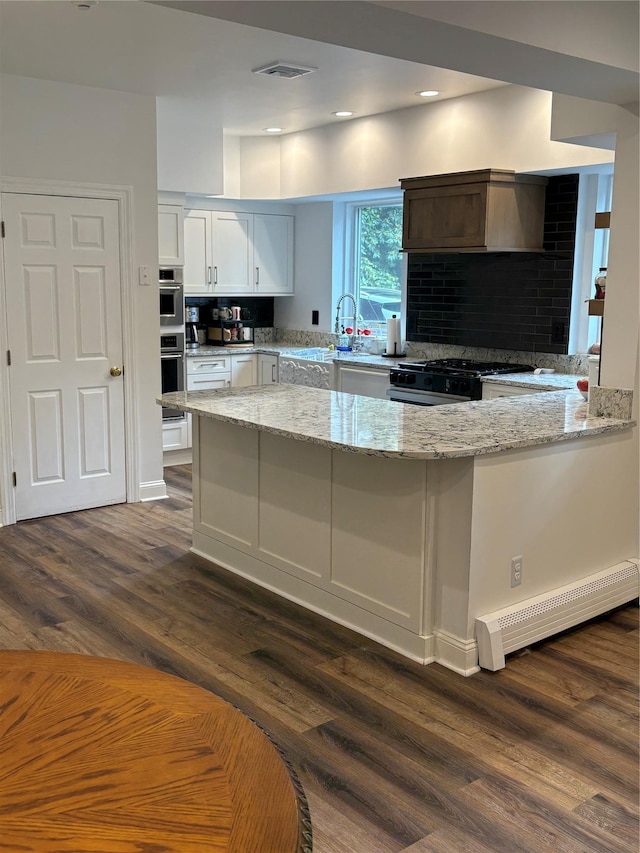 84 Highview Ave, Nanuet, NY 10954 - kitchen with range with gas stovetop, light stone countertops, dark wood-type flooring, white cabinets, and recessed lighting