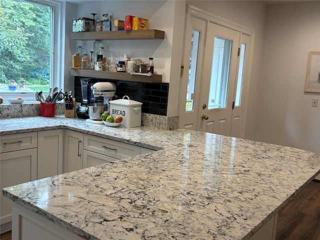 84 Highview Ave, Nanuet, NY 10954 - kitchen featuring healthy amount of natural light, white cabinets, and light stone counters