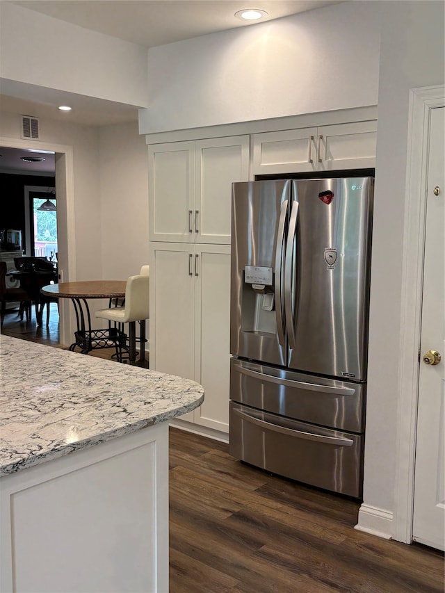 84 Highview Ave, Nanuet, NY 10954 - kitchen with stainless steel refrigerator with ice dispenser, dark wood-style floors, light stone counters, recessed lighting, and white cabinets