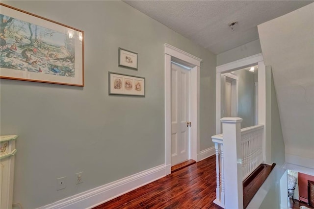84 Highview Ave, Nanuet, NY 10954 - hall with dark wood-style floors, a textured ceiling, and an upstairs landing