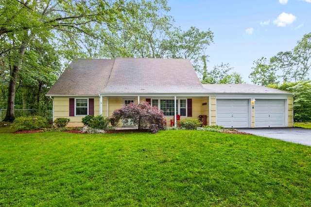 5 Seward Ln, Stony Brook, NY 11790 - view of front of property with an attached garage, asphalt driveway, and a front lawn