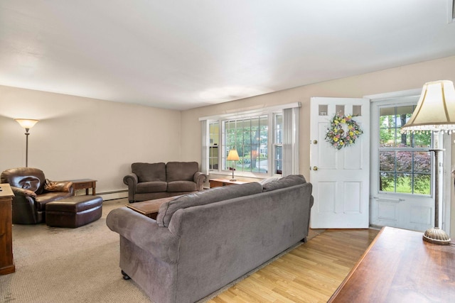 5 Seward Ln, Stony Brook, NY 11790 - living area featuring plenty of natural light, a baseboard heating unit, and light wood-type flooring