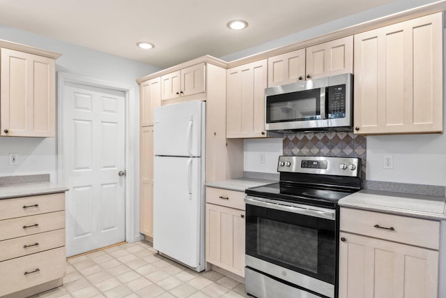 5 Seward Ln, Stony Brook, NY 11790 - kitchen with appliances with stainless steel finishes, light countertops, backsplash, recessed lighting, and light flooring