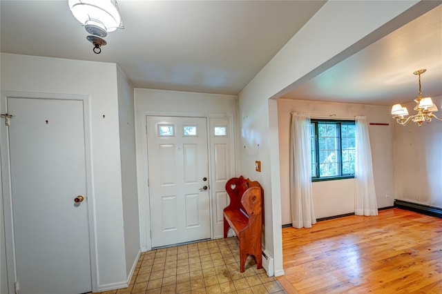 26 Village Ln, Hauppauge, NY 11788 - foyer entrance with a chandelier and a baseboard heating unit