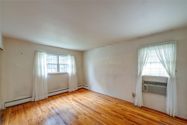 26 Village Ln, Hauppauge, NY 11788 - empty room with a baseboard heating unit and light wood-type flooring