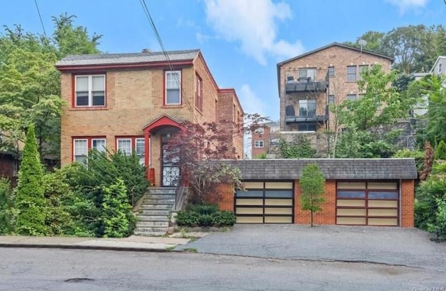 1089-1091 Mile Square Rd, Yonkers, NY 10704 - view of front of home with brick siding and a garage