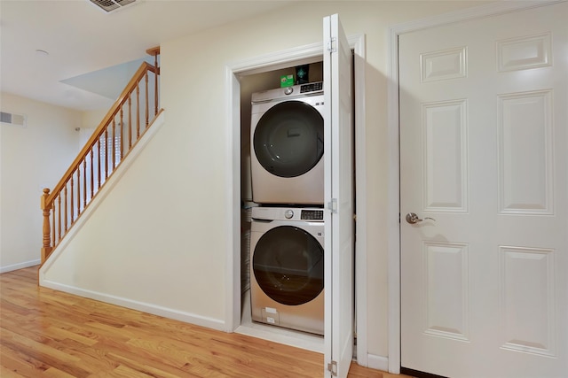 32 Janet Ln, Breezy Point, NY 11697 - washroom featuring stacked washer and clothes dryer and light wood-style flooring