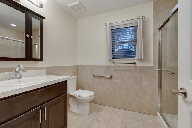 32 Janet Ln, Breezy Point, NY 11697 - full bath featuring tile patterned flooring, tile walls, vanity, a stall shower, and a wainscoted wall