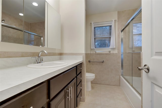 32 Janet Ln, Breezy Point, NY 11697 - bathroom featuring tile walls, tile patterned flooring, vanity, enclosed tub / shower combo, and recessed lighting