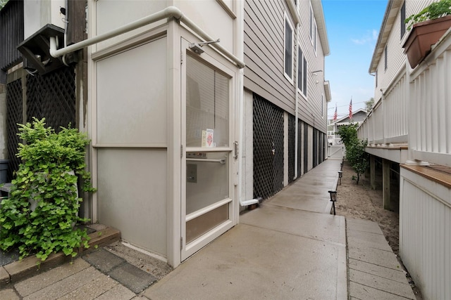 32 Janet Ln, Breezy Point, NY 11697 - view of side of home featuring stucco siding