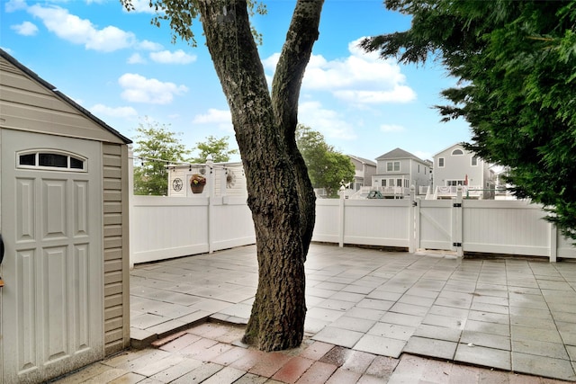 32 Janet Ln, Breezy Point, NY 11697 - view of patio featuring a gate and a residential view