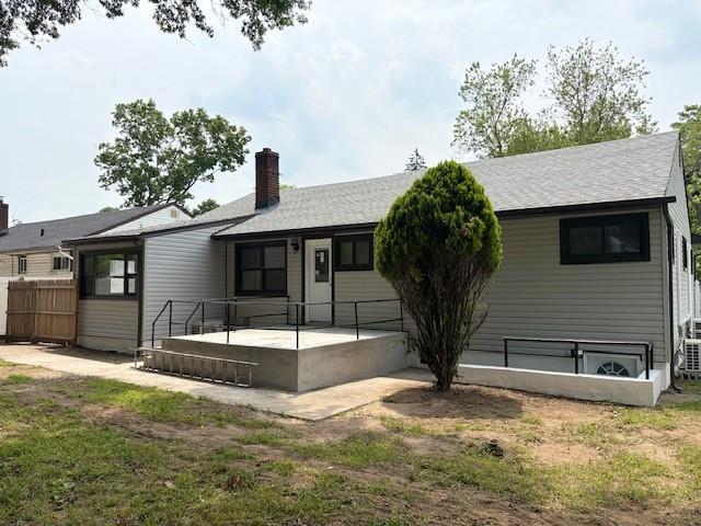 747 Janos Ln, West Hempstead, NY 11552 - back of house with a chimney and a shingled roof