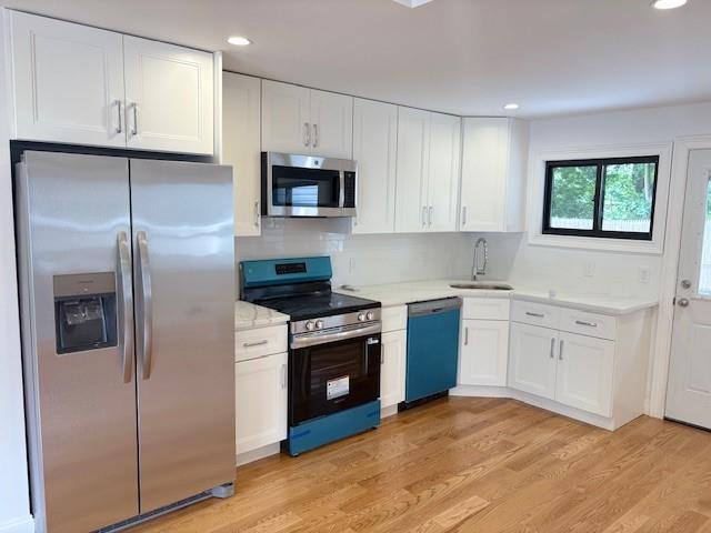747 Janos Ln, West Hempstead, NY 11552 - kitchen featuring stainless steel appliances, white cabinets, light wood finished floors, and recessed lighting