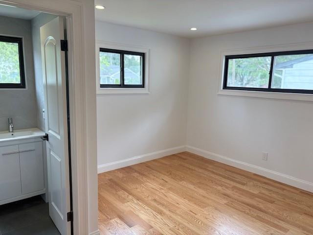 747 Janos Ln, West Hempstead, NY 11552 - spare room featuring plenty of natural light, light wood-style flooring, and recessed lighting