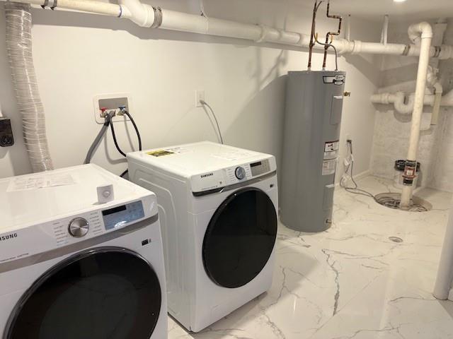 747 Janos Ln, West Hempstead, NY 11552 - laundry room with electric water heater, washer and clothes dryer, and light marble finish floors