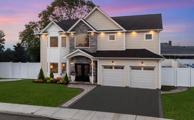 4 Heron Ct, Levittown, NY 11756 - view of front facade featuring asphalt driveway, stone siding, a garage, and french doors