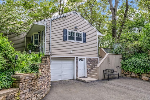 259 Little Plains Rd, Huntington, NY 11743 - view of front of house featuring a garage, stone siding, stairway, and asphalt driveway