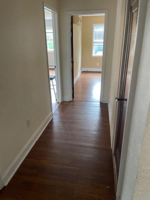 60 Hartsdale Rd, Elmsford, NY 10523 - hallway with wood finished floors, a baseboard heating unit, and a wall mounted air conditioner